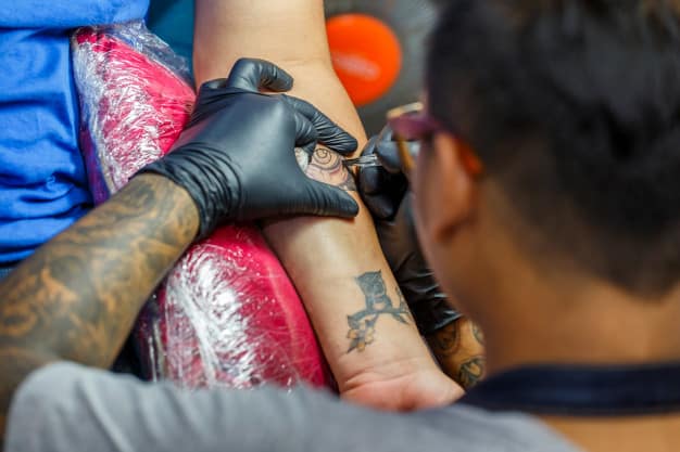 homem fazendo tatuagem